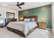 Cozy bedroom showcasing carpet, a ceiling fan, a rustic wood headboard, and bedside tables with lamps at 9807 Rosalee Peak St, Littleton, CO 80125