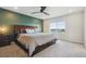 Relaxing bedroom with an accent wall, a ceiling fan, a window with natural light, and a carpeted floor at 9807 Rosalee Peak St, Littleton, CO 80125