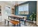 Sunlit dining area features bench seating, an modern chandelier, and a wine rack for entertaining guests at 9807 Rosalee Peak St, Littleton, CO 80125