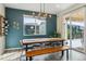 Inviting dining room with table and bench seating with modern light fixture and sliding door to the patio at 9807 Rosalee Peak St, Littleton, CO 80125