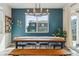 Dining room with long table, seating and modern chandelier with sliding door leading to the backyard at 9807 Rosalee Peak St, Littleton, CO 80125