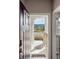 Inviting entryway with a view of the neighborhood, featuring a stylish door and neutral decor at 9807 Rosalee Peak St, Littleton, CO 80125