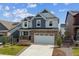 Beautiful two-story home with brick facade, two-car garage, and well-manicured lawn at 9807 Rosalee Peak St, Littleton, CO 80125