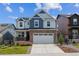 Charming two-story home featuring a brick front, white garage door, and a landscaped yard at 9807 Rosalee Peak St, Littleton, CO 80125