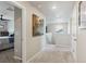 Hallway with neutral colors, and access to bedroom. Artwork adds charm at 9807 Rosalee Peak St, Littleton, CO 80125