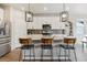 Stylish kitchen with white cabinetry, stainless steel appliances, and a large center island with bar stools at 9807 Rosalee Peak St, Littleton, CO 80125