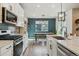 Well-lit kitchen with stainless steel appliances, light countertops, and an island, perfect for cooking at 9807 Rosalee Peak St, Littleton, CO 80125