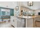 Bright, open kitchen with stainless steel appliances and eat-in island that flows into the dining area at 9807 Rosalee Peak St, Littleton, CO 80125