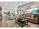Spacious living room with modern furnishings, fireplace, and large sliding doors to the backyard at 9807 Rosalee Peak St, Littleton, CO 80125