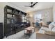 Entertainment room with TV, shelving, and sofa, offering a cozy spot for relaxation at 9807 Rosalee Peak St, Littleton, CO 80125
