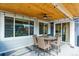 Covered patio with outdoor dining and ceiling fan, perfect for entertaining at 9807 Rosalee Peak St, Littleton, CO 80125