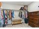 Walk-in closet with ample storage, including hanging rods, shelves, and a wood dresser at 9807 Rosalee Peak St, Littleton, CO 80125