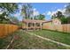 The backyard features a charming pergola, a grassy area, and a walkway leading to a detached structure at 1439 Dexter St, Denver, CO 80220