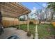 Spacious backyard with a wooden pergola, green grass, and potential for outdoor enjoyment at 1439 Dexter St, Denver, CO 80220