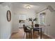 Bright dining area with views into the kitchen and featuring a stylish light fixture at 1439 Dexter St, Denver, CO 80220