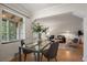 Open dining area with hardwood floors, natural light, and views into a stylishly decorated living room at 1439 Dexter St, Denver, CO 80220