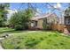 Charming home featuring a brick exterior, a well-manicured lawn, and mature trees, creating curb appeal at 1439 Dexter St, Denver, CO 80220