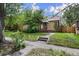 Charming brick home featuring a well-maintained front yard and mature trees offering shade at 1439 Dexter St, Denver, CO 80220