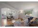 Open living room with hardwood floors, a dining area, and a view into a modern kitchen at 1439 Dexter St, Denver, CO 80220