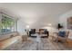 Cozy living room featuring a large window, modern furnishings, and hardwood floors at 1439 Dexter St, Denver, CO 80220