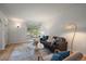 Bright living room featuring hardwood floors, a large window, and modern furnishings with neutral colors at 1439 Dexter St, Denver, CO 80220