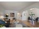 Bright and open concept living room with hardwood floors, stylish decor, and an open archway at 1439 Dexter St, Denver, CO 80220