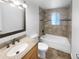 Updated bathroom with a shower/tub combo and granite vanity at 4620 W Alaska Pl, Denver, CO 80219