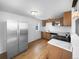 Modern kitchen featuring wood cabinets and marble countertops at 4620 W Alaska Pl, Denver, CO 80219