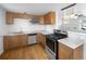 Updated kitchen with modern appliances and wood cabinetry at 4620 W Alaska Pl, Denver, CO 80219