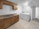 Basement laundry room with washer, dryer and cabinets at 4620 W Alaska Pl, Denver, CO 80219