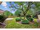 Beautiful backyard with a large tree, lush green grass, and well-maintained landscaping for outdoor enjoyment at 8182 Sweet Water Rd, Lone Tree, CO 80124