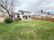 Large backyard with mature trees and a patio, offering plenty of space for outdoor activities at 8182 Sweet Water Rd, Lone Tree, CO 80124