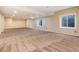 Large basement area with carpet, bright lighting, and several windows at 8182 Sweet Water Rd, Lone Tree, CO 80124