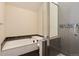 Modern bathroom with a soaking tub, a tiled shower with glass door, and neutral tones at 8182 Sweet Water Rd, Lone Tree, CO 80124