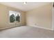 Bedroom with neutral colored carpet and a window overlooking the front yard at 8182 Sweet Water Rd, Lone Tree, CO 80124