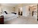 Primary bedroom featuring neutral carpet, vaulted ceiling, and ensuite bathroom at 8182 Sweet Water Rd, Lone Tree, CO 80124