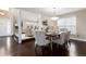 Open concept dining room leading to living room with hardwood floors and modern chandelier at 8182 Sweet Water Rd, Lone Tree, CO 80124