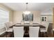 Well-lit dining room with a chandelier over a dark wood table and comfortable upholstered chairs at 8182 Sweet Water Rd, Lone Tree, CO 80124