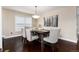 Well-lit dining room with a chandelier over a dark wood table and comfortable upholstered chairs at 8182 Sweet Water Rd, Lone Tree, CO 80124