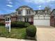 Charming two-story home featuring a two-car garage, brick accents and well-manicured front lawn at 8182 Sweet Water Rd, Lone Tree, CO 80124