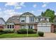 Charming two-story home with brick accents, manicured lawn, and a two-car garage at 8182 Sweet Water Rd, Lone Tree, CO 80124