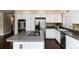 Spacious kitchen with stainless steel appliances, a center island cooktop, and ample cabinetry for storage at 8182 Sweet Water Rd, Lone Tree, CO 80124