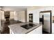 Open-concept living space with seamless flow from the modern kitchen featuring stainless appliances and a center island at 8182 Sweet Water Rd, Lone Tree, CO 80124
