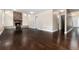 Open living area with hardwood floors and brick fireplace creates a warm and inviting atmosphere in the home at 8182 Sweet Water Rd, Lone Tree, CO 80124