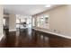 Bright living room with hardwood floors and large windows, seamlessly connected to the adjacent kitchen space at 8182 Sweet Water Rd, Lone Tree, CO 80124