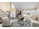 Bright living room featuring vaulted ceilings, fireplace, neutral color palette, and large windows at 8182 Sweet Water Rd, Lone Tree, CO 80124