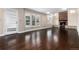 Spacious living room boasting hardwood floors, natural light, and a cozy brick fireplace at 8182 Sweet Water Rd, Lone Tree, CO 80124