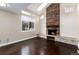 Cozy living room with brick fireplace and large windows, offering natural light and a comfortable space at 8182 Sweet Water Rd, Lone Tree, CO 80124