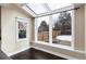 Sunroom features large windows with a view of the backyard and a vaulted ceiling with skylights at 8182 Sweet Water Rd, Lone Tree, CO 80124