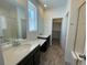 Bathroom with double vanity, quartz countertops, and walk-in shower at 4799 Astor Pl, Brighton, CO 80601